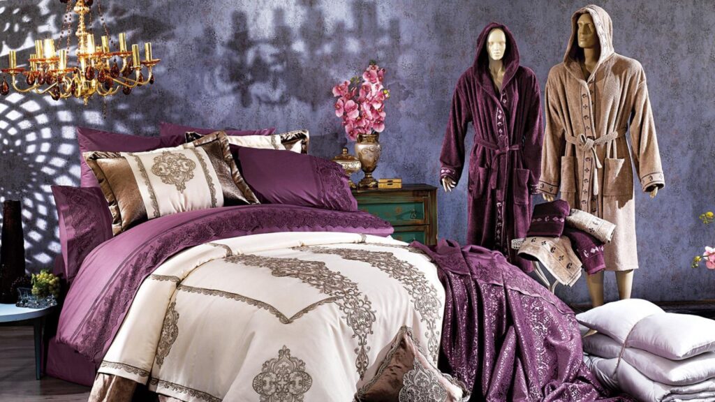 A neatly made bed with a soft robe and cozy blanket, showcasing textile products
